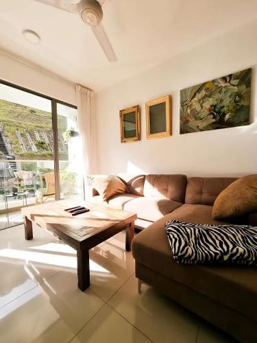 a living room with a couch and a coffee table at Mossy Forest Family Retreat II, 2-8 pax, Cameron Highlands in Cameron Highlands