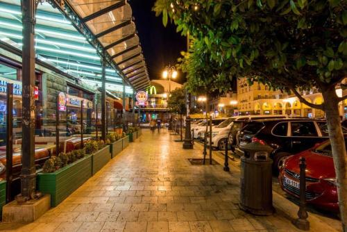 a city street at night with cars parked at HOTEL IMERETI TBILISi in Tbilisi City