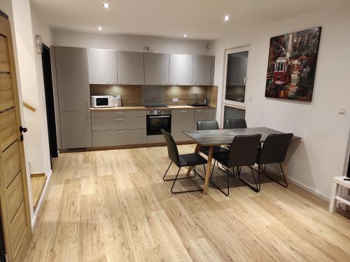 a kitchen and dining room with a table and chairs at Seepark 13a in Goch