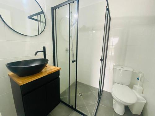 a bathroom with a sink and a toilet and a mirror at New- Luxury Glil Yam For Family 4 Rooms Parking in Herzliya
