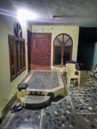 Zimmer mit einem Bett und einer Holztür in der Unterkunft Vrindavan Home Stay,Varanasi. in Varanasi