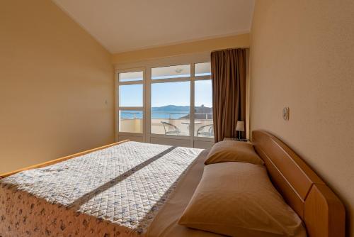 A bed or beds in a room at VILLA Karolina by the sea