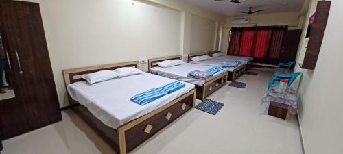 a bedroom with two beds and a window at aapka ujjain homestay in Ujjain