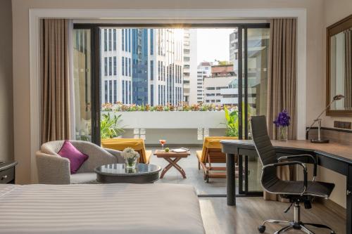a hotel room with a bed and a view of a city at Boulevard Hotel Bangkok Sukhumvit in Bangkok