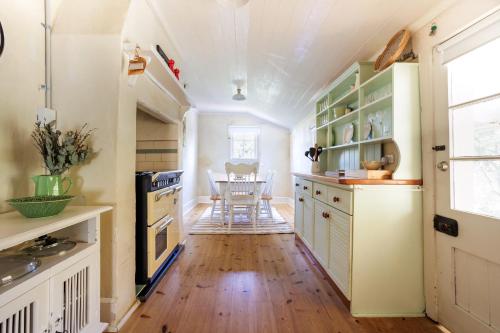 a kitchen with wooden floors and a table with chairs at Wollaston House by the BnB Collection in Albany