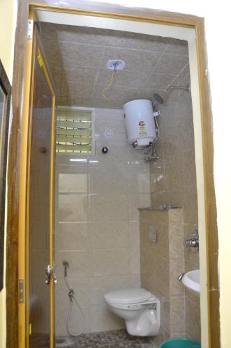a small bathroom with a toilet and a sink at aapka ujjain homestay in Ujjain