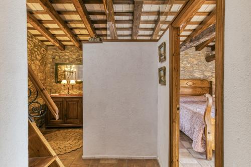 a bedroom with a bed in a room with wooden ceilings at Can Roca in Montiró
