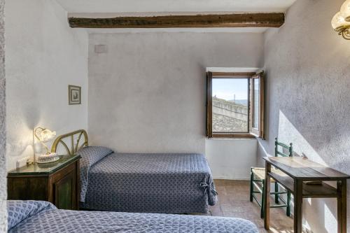 a bedroom with two beds and a window at Can Roca in Montiró