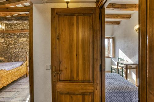 a door leading to a bedroom with two beds at Can Roca in Montiró