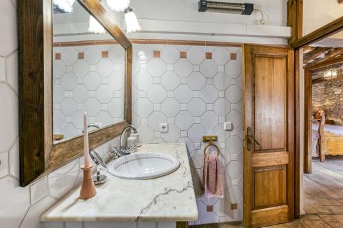 a bathroom with a sink and a mirror at Can Roca in Montiró