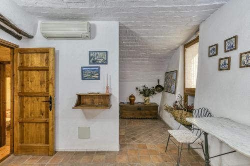 a hallway with a door and a table and chairs at Can Roca in Montiró