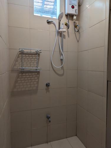 a shower in a bathroom with a shower at Aquaventure Reef Club in Mabini