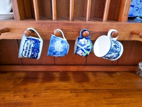 a group of blue and white pottery on a shelf at Mossy Forest Family Retreat II, 2-8 pax, Cameron Highlands in Cameron Highlands