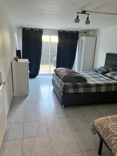 - une chambre dotée d'un lit avec des rideaux bleus dans l'établissement Appartement T3 avec accès jardin a 20 minutes de la Gare, à Juvisy-sur-Orge