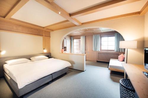 a hotel room with a bed and a desk and a desk at Schönherr Haus in Neustift im Stubaital