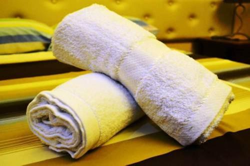 a rolled up towel sitting on top of a bed at Julieta's Pension House in Puerto Princesa City
