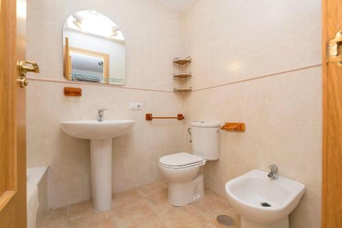 a bathroom with a toilet and a sink at Paraiso Costero - Adults Only - in Conil de la Frontera