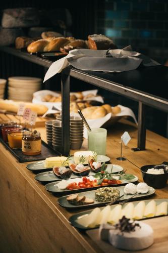 a buffet with plates of food on a table at Schönherr Haus in Neustift im Stubaital