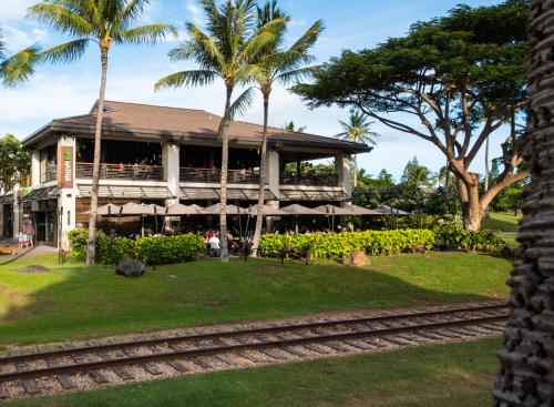 a building with palm trees in front of it at Ko Olina Beach Villas B602 in Kapolei