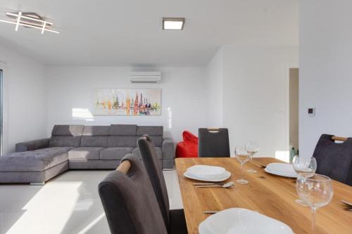 a living room with a table and a couch at Premium Apartments in Vantačići