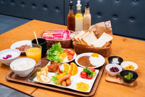 a tray of food with different types of food on a table at Travelodge Honmachi Osaka in Osaka
