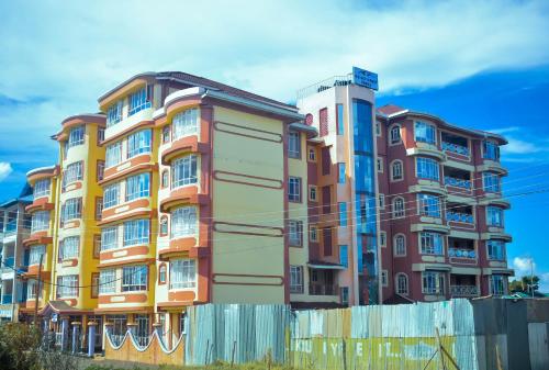 a colorful building with a fence in front of it at Balozi Luxury Homes in Nanyuki