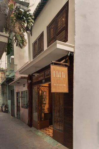 a building with a sign on the side of it at Ben Thanh Vietnamese cultural house by SSens Homes in Ho Chi Minh City