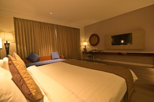 Postel nebo postele na pokoji v ubytování Hotel Amaravathi