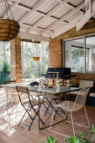 a dining room with a table and chairs at Bushy Sleeps - Eco Friendly Tranquil Escape in Gnarabup