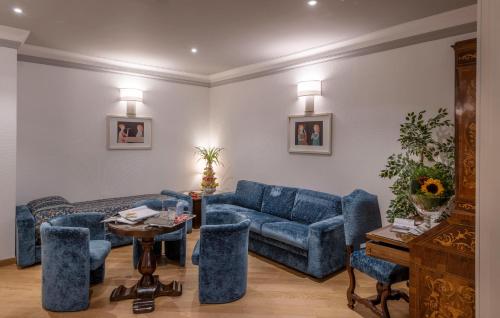 a living room with blue couches and a table at Rivoli Boutique Hotel in Florence
