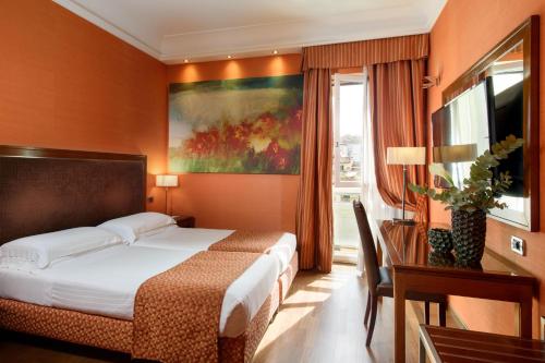 a hotel room with a bed and a window at Grand Hotel Adriatico in Florence