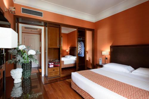 a hotel room with a large bed and a bedroom at Grand Hotel Adriatico in Florence