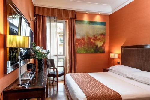 a hotel room with a bed and a window at Grand Hotel Adriatico in Florence