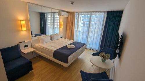 a hotel room with a bed and a mirror at Orbi City, block C in Batumi