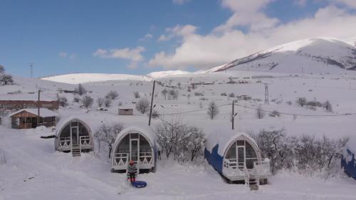 three domes in the snow with a mountain in the background at Glamping Eco Valley in Shahumyan