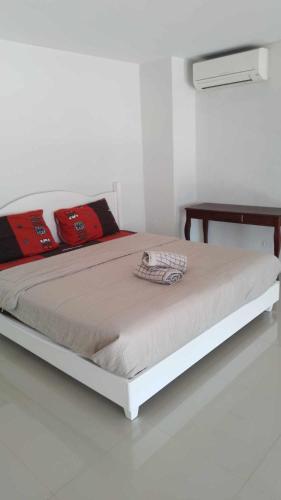 a white bed in a white room with a white floor at GrandBeach Duplex Sea view by malai in Ban Tha Fat