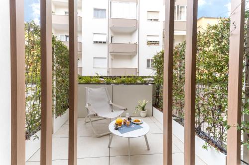 a balcony with a table and chairs and a building at Open Hotel in Rimini