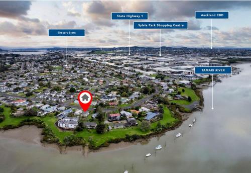 an aerial view of a suburb with a red marker at Waterfront villa near IKEA and Sylvia Park in Auckland