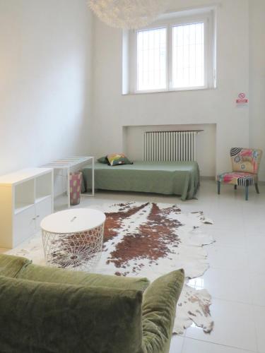 a living room with a couch and a table at Appartamento open space in Turin