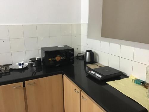 a kitchen with a counter top with a coffee maker on it at Chez Bussy in Puducherry