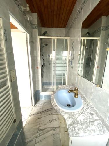 une salle de bain avec un lavabo et une douche dans l'établissement MAISON FLEURIE quartier calme, à Arcachon