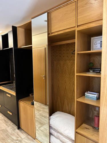 a room with a closet with wooden shelves at Zama Suites in Zakynthos Town