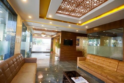 a lobby with a couch and a table in a building at Sai Vidisha Palace in Shirdi