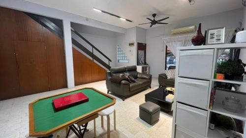 a living room with a couch and a table at 311 Nana’s Homes BBQ, Games, Netflix 11pax in Ampang