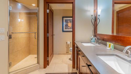 a bathroom with two sinks and a shower at Ko Olina Beach Villas B706 in Kapolei