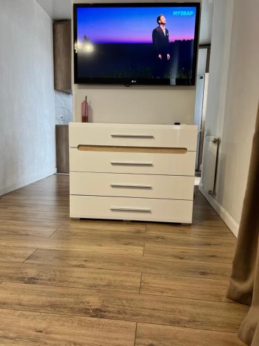 a flat screen tv sitting on top of a dresser at Belveder Center Home in Ivano-Frankivsk