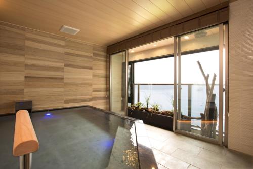 a pool in a room with a view of the ocean at Hakone Hotel in Hakone
