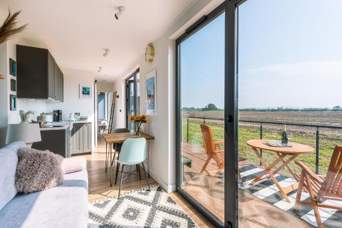 a kitchen and living room with a view of the field at the BOX BNB in Wilton