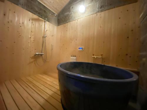 a large tub in a room with wooden floors at 貸切御宿　憩（Ikoi）/ Nikko Kinugawa Area in Imaichi