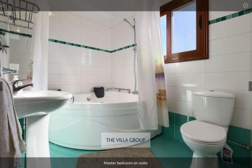 a bathroom with a tub and a toilet and a sink at Nayia Paradise Villa! Best Villa in Cyprus in Paphos City